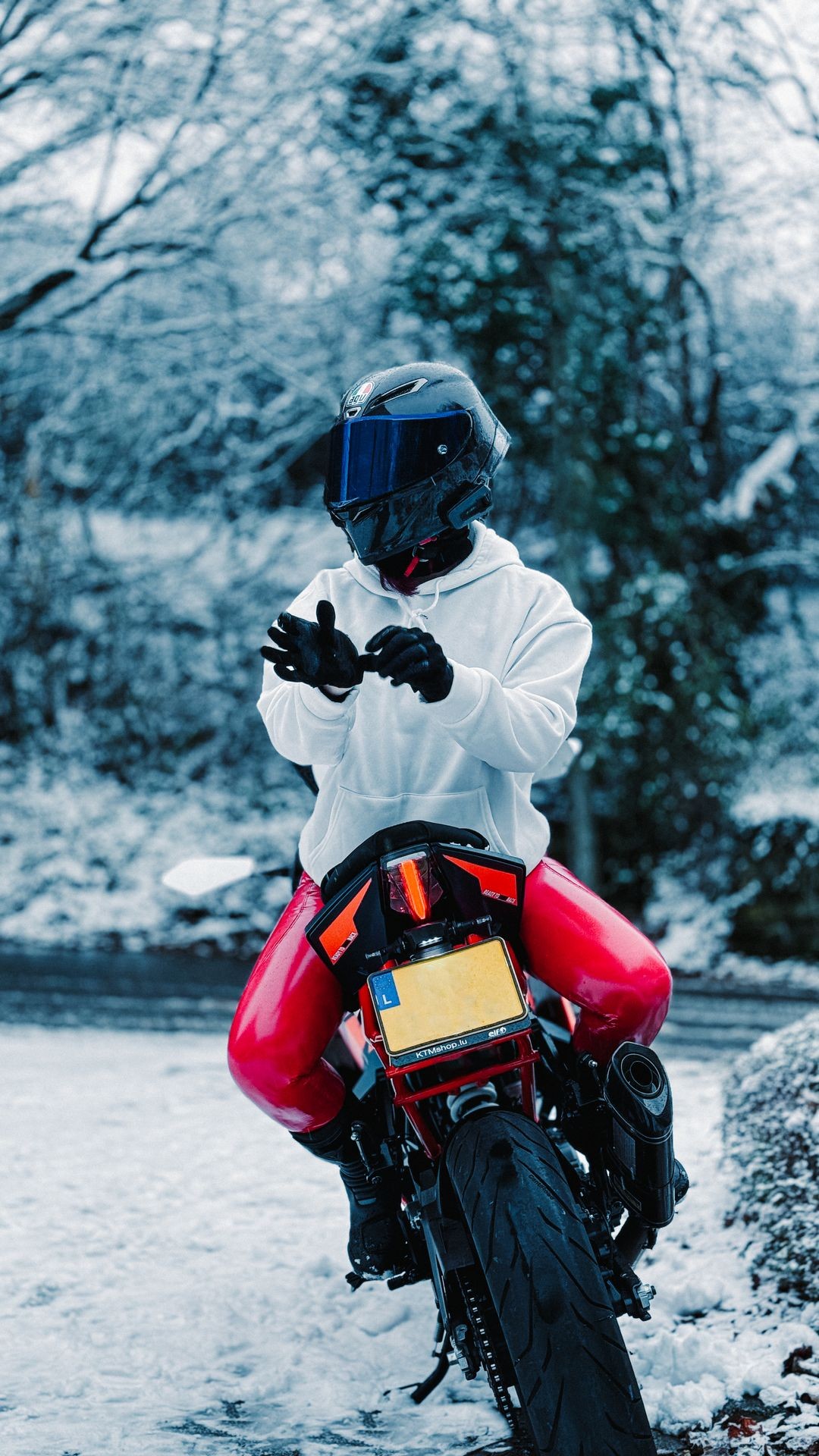 one women sitting on a motorcycle in snow